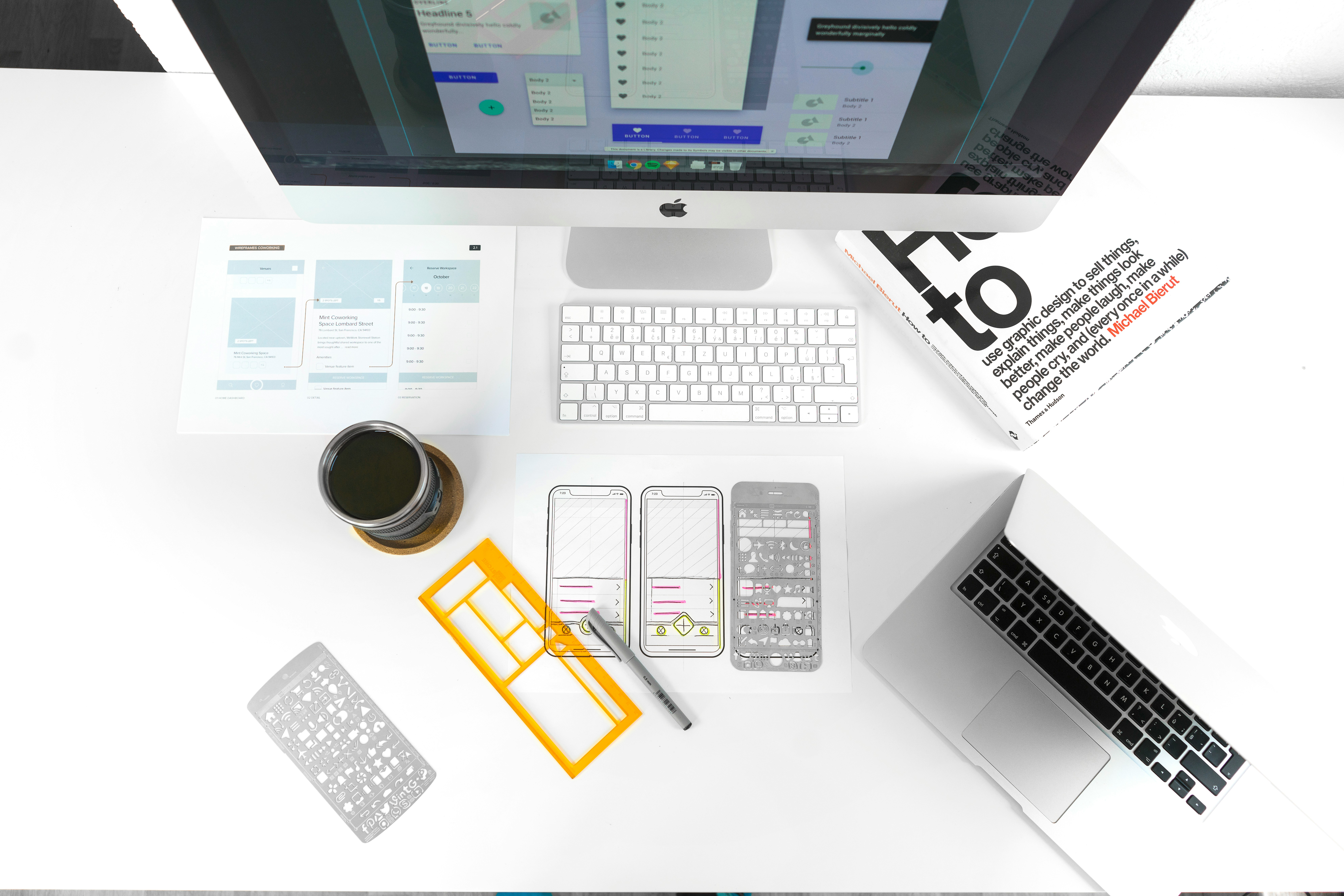 Designer workspace with Mac, mobile wireframe stencils and iPhone prototypes